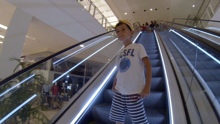 eli-on-escalator-in-mall